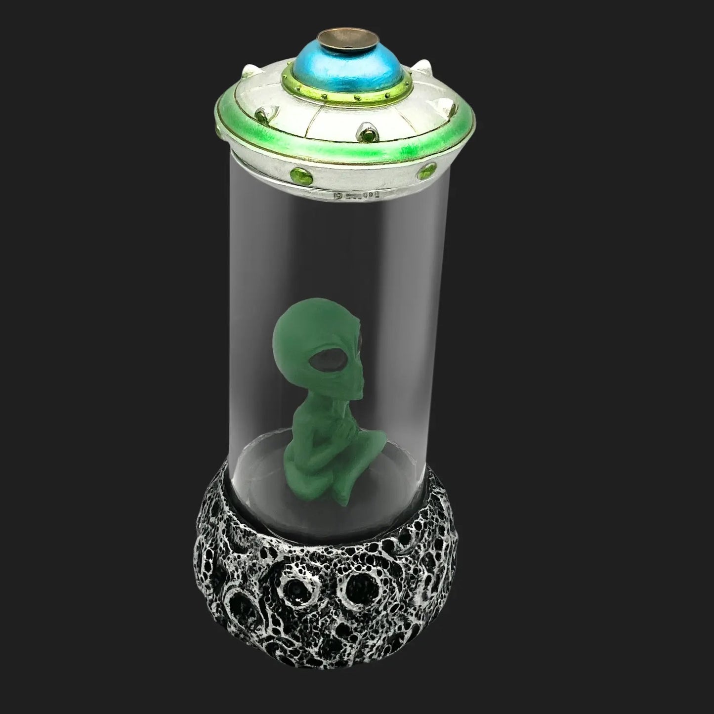 Angled view of alien UFO incense burner with light-up saucer top and cratered base