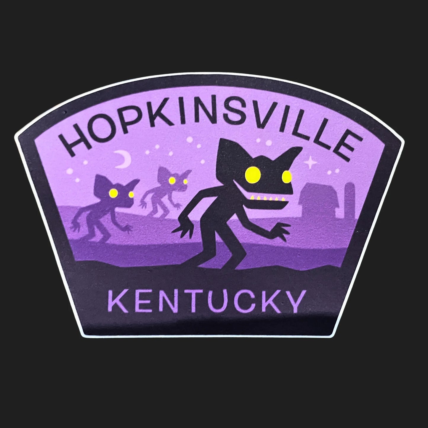 Hopkinsville Goblins sticker in purple with glowing-eyed cryptids from the 1955 Kentucky encounter