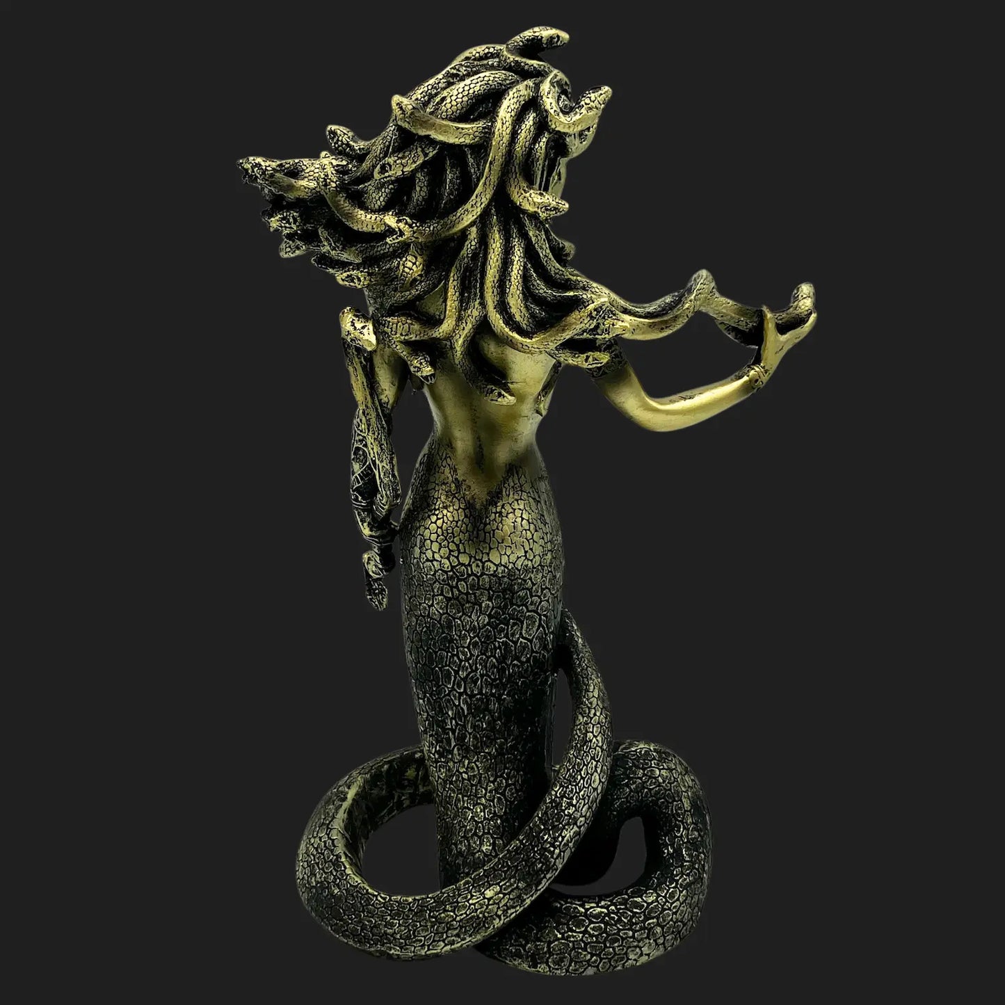 Back view of Medusa figurine showing coiled serpent tail and intricate scales
