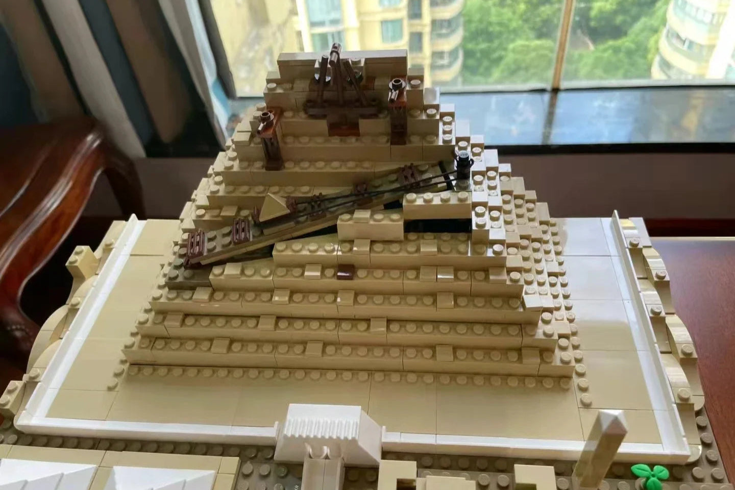 Close-up of pyramid under construction with brick ramps and scaffolding detail