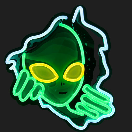 Green alien neon sign glowing on black wall – UFO inspired LED decor