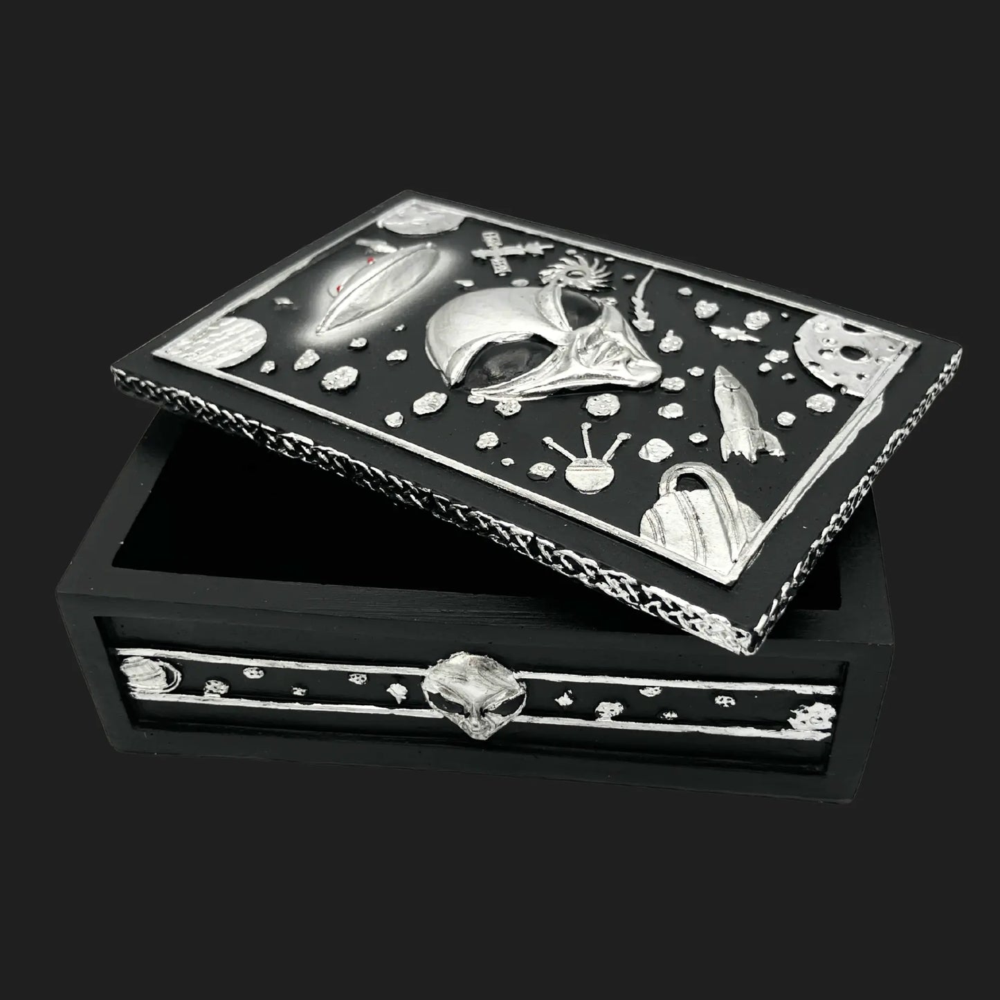 Alien trinket box with open lid showing UFO, planets, and extraterrestrial face carved in silver cosmic design