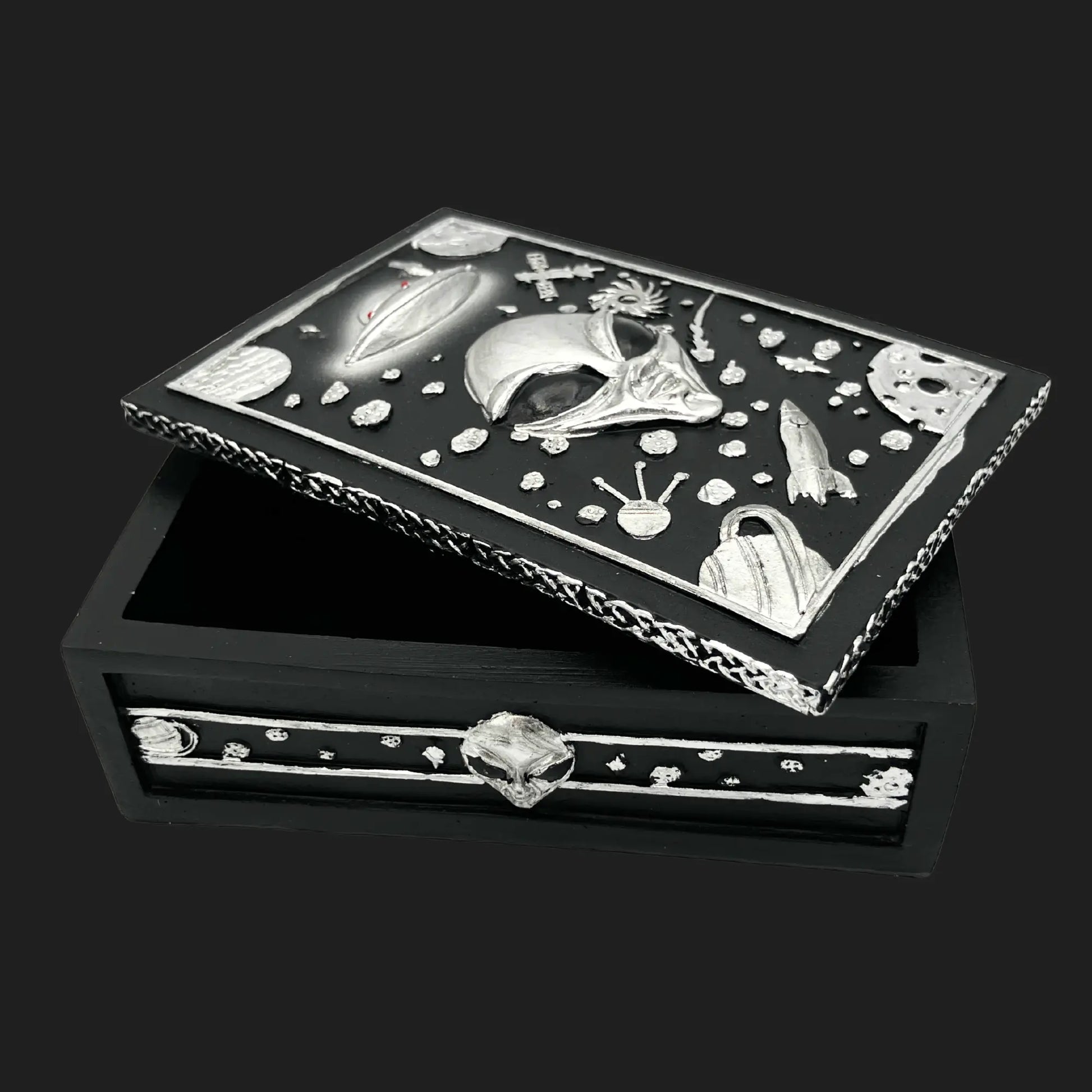Alien trinket box with open lid showing UFO, planets, and extraterrestrial face carved in silver cosmic design