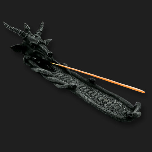 Baphomet incense burner holding lit incense stick on serpent tray