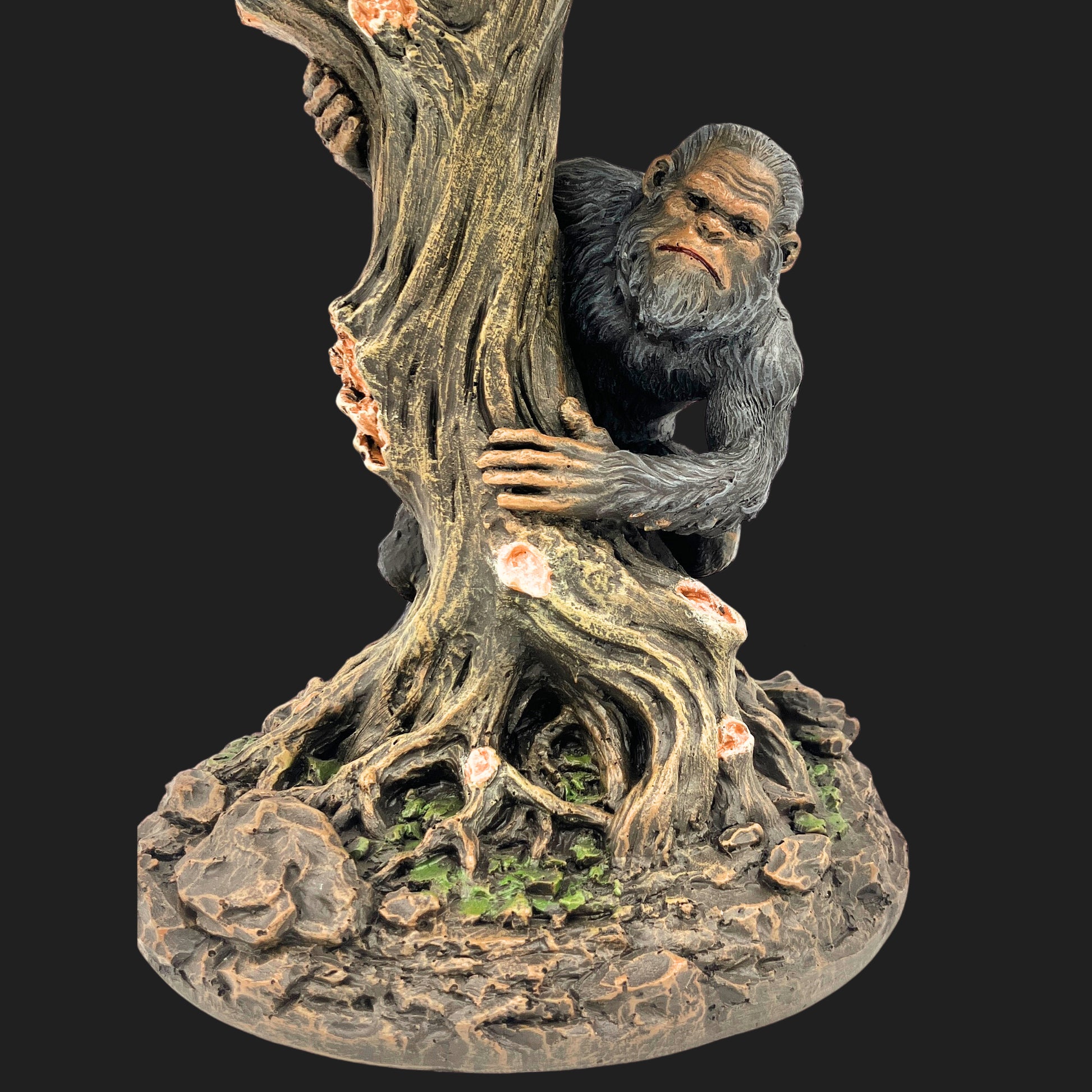 Bigfoot figure partially hidden behind a gnarled tree trunk on a forest-themed lamp base