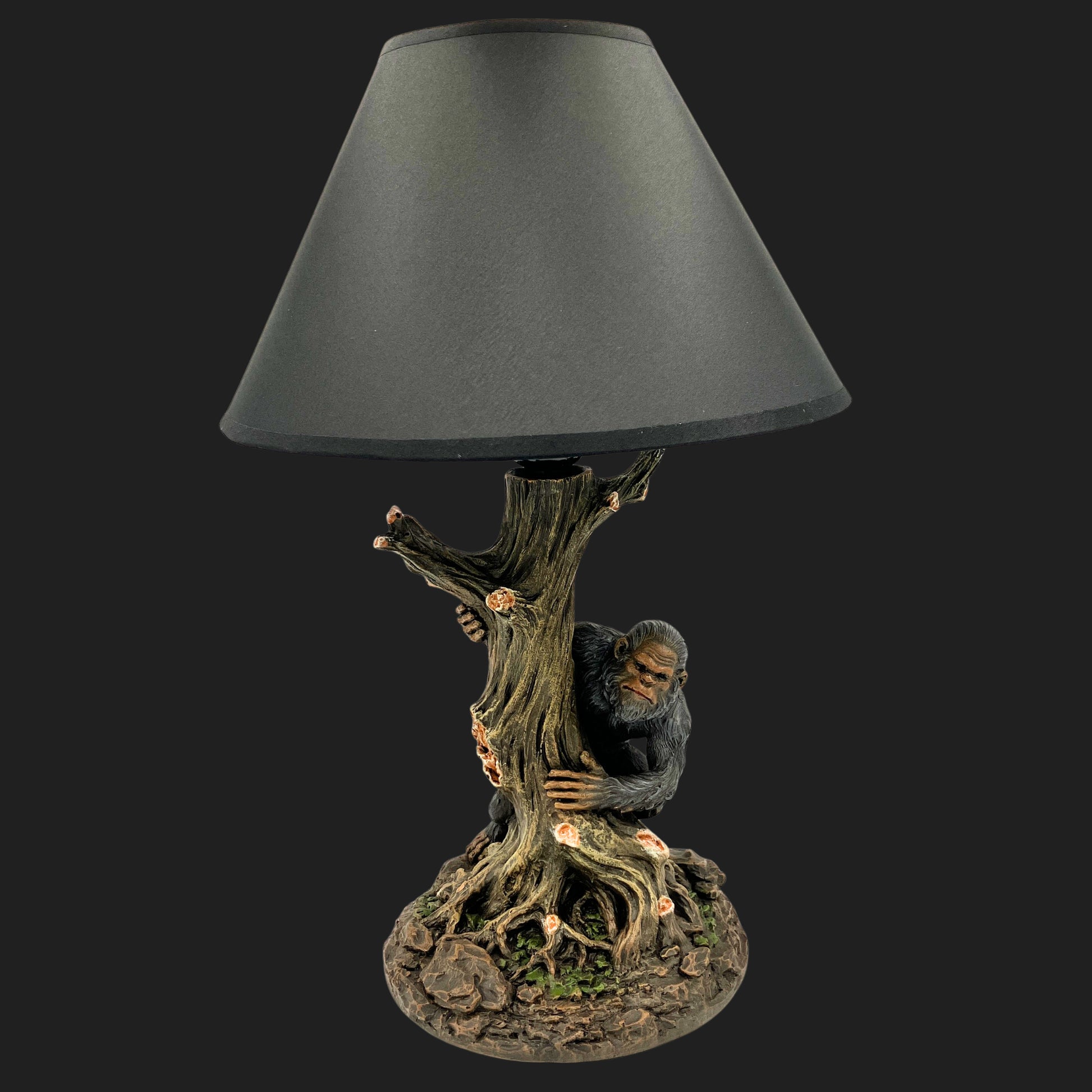 Bigfoot forest-themed table lamp with dark shade, approximately 16 inches tall