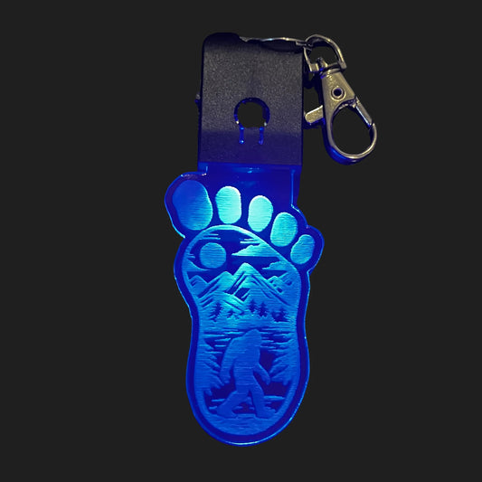  Bigfoot LED charm glowing blue in footprint design