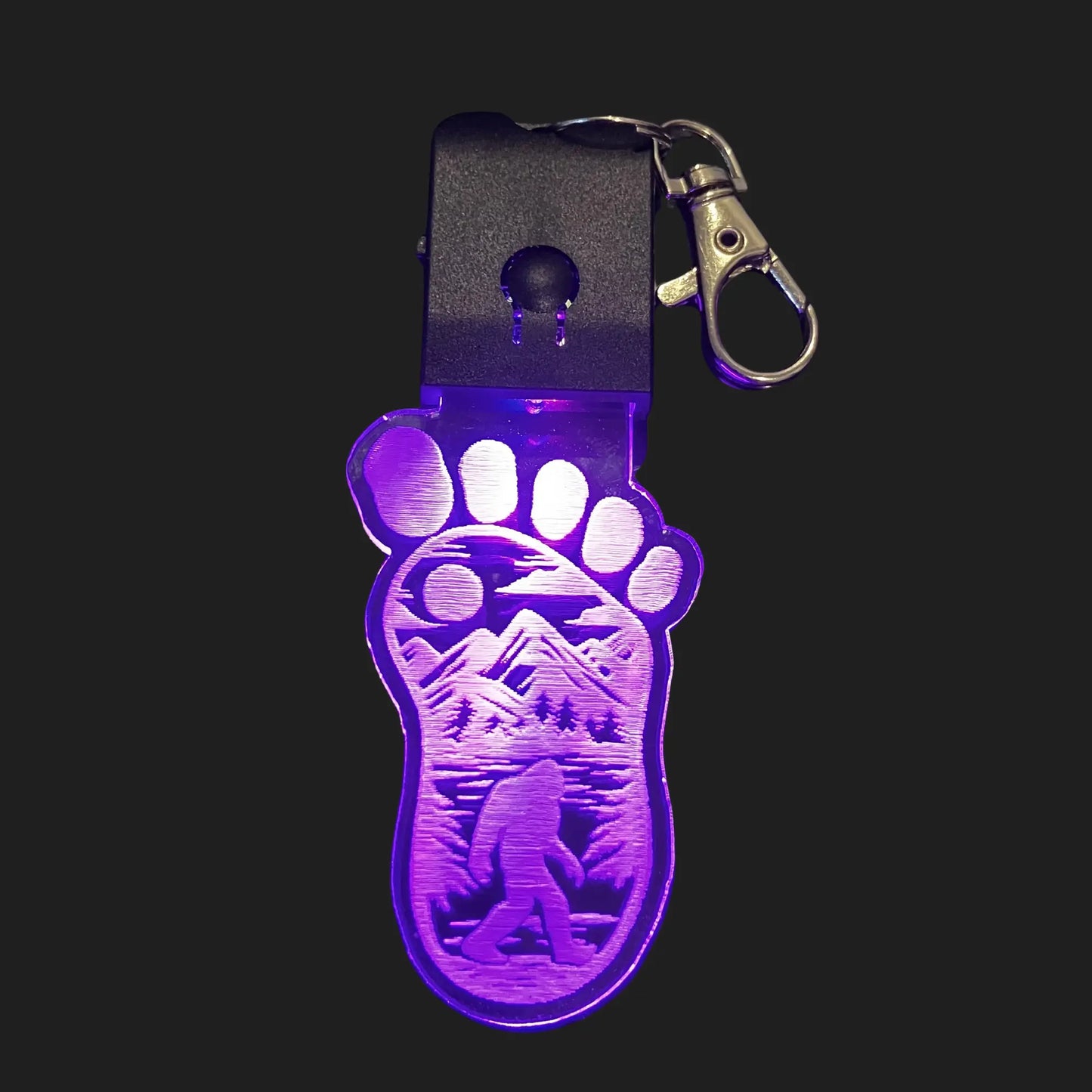  Bigfoot LED keychain glowing purple with mountain scene and Sasquatch silhouette