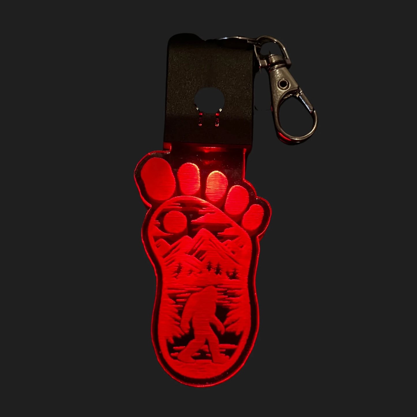 Bigfoot footprint LED charm glowing red with etched Sasquatch design