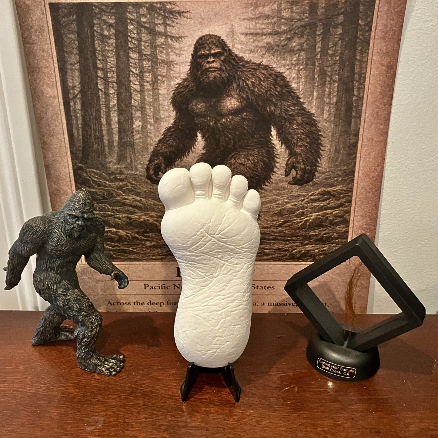 Bigfoot mini cast footprint displayed in themed setup with Bigfoot figure, artwork, and collectible props
