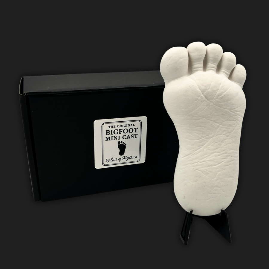 Bigfoot mini cast footprint displayed on stand with black gift box packaging by Lair of Mythics