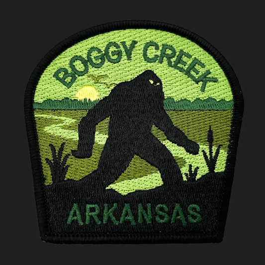 Embroidered Boggy Creek Monster iron-on patch, 3x3 inches, featuring Fouke Monster silhouette in Arkansas swamp with sunset.
