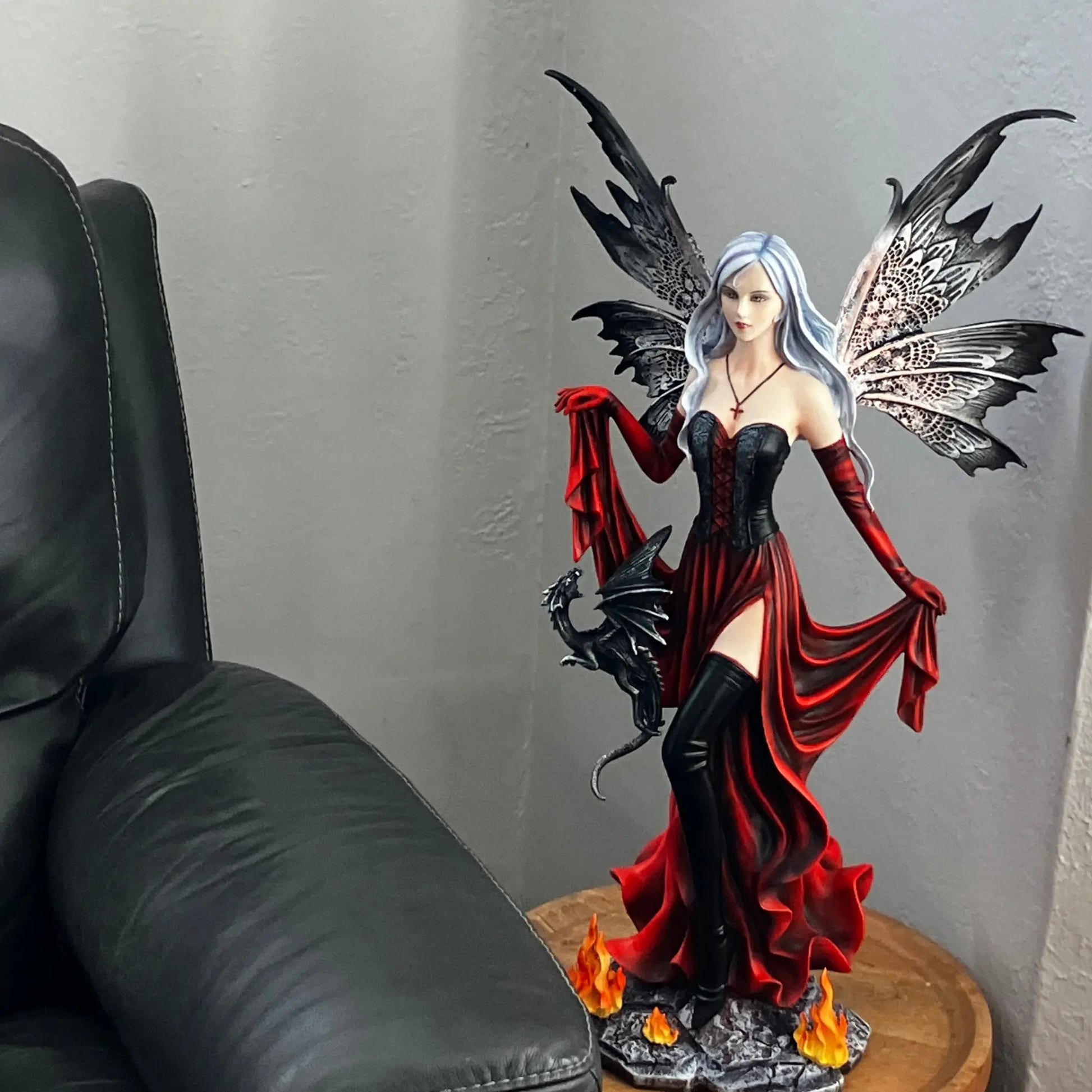 Dark fairy collectible with silver hair, corset dress, and butterfly wings in black and white tones