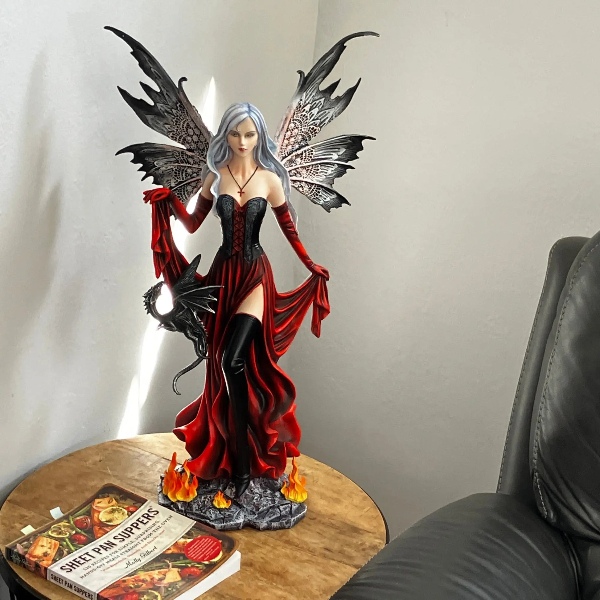 Enchantress fairy gothic décor statue featuring red gown, thigh-high boots, and dragon companion