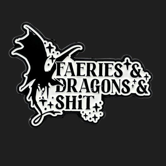 Black and white enamel pin with a dragon silhouette and the phrase “Faeries & Dragons & Shit.”
