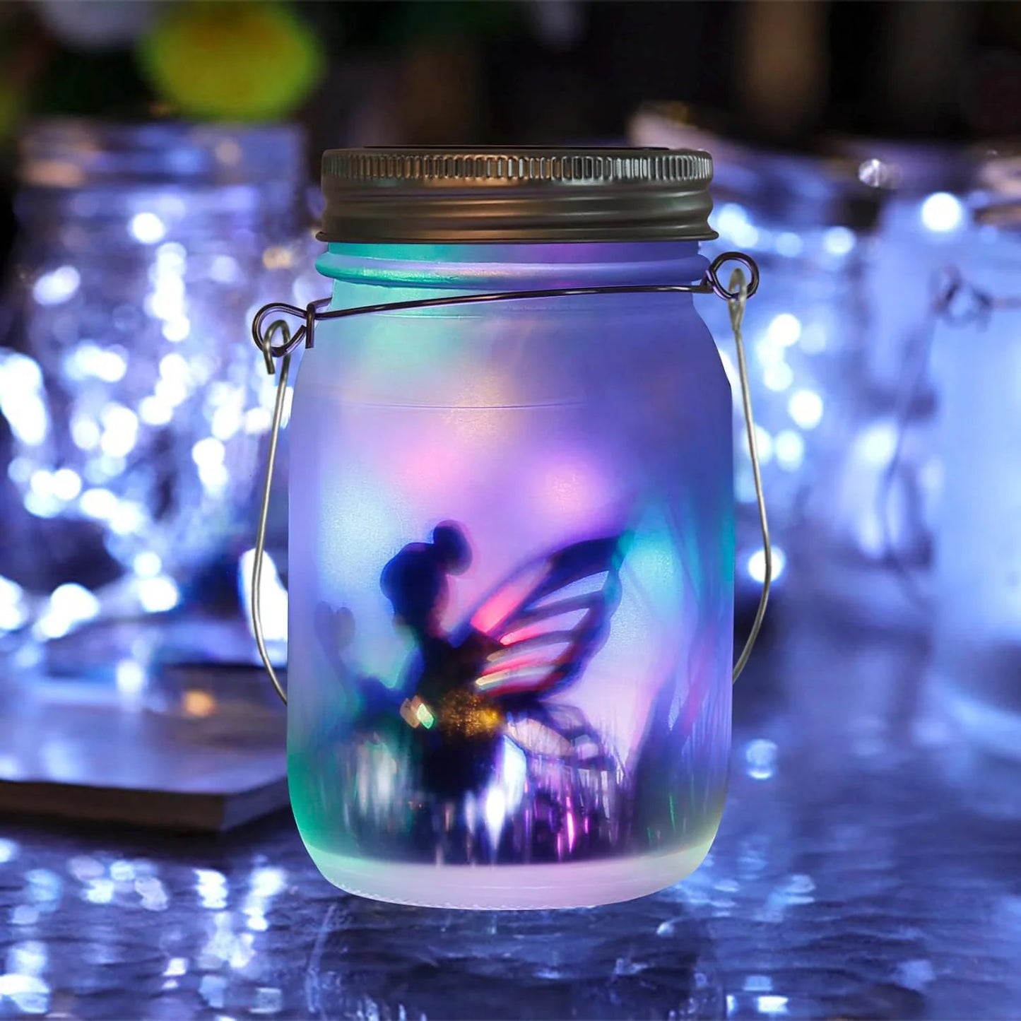 Fairy silhouette inside frosted mason jar glowing with rainbow LED lights on a reflective surface at night