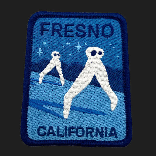 Embroidered Fresno Nightcrawlers iron-on patch, 2.5 x 3 inches, featuring white leggy cryptids walking under stars in California night sky.