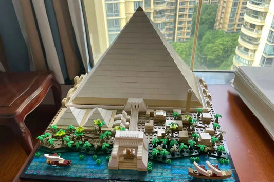 Front view of complete pyramid building set displayed near window with city view
