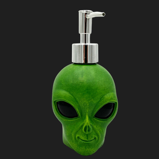 Front view of green alien head soap or lotion dispenser with chrome pump