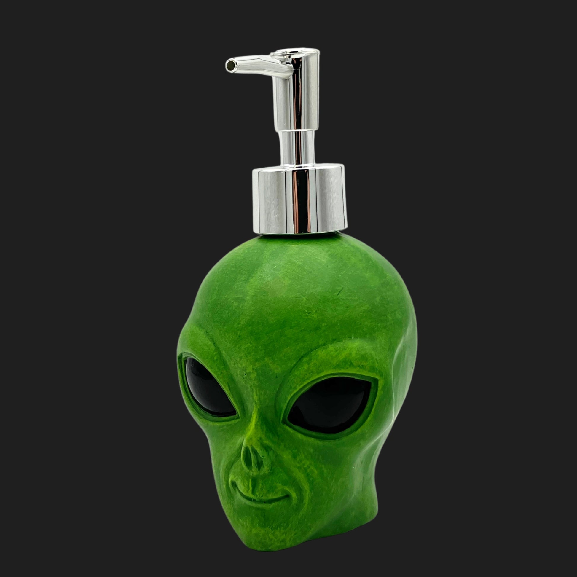 Green alien head soap or lotion dispenser with chrome pump, side angle view