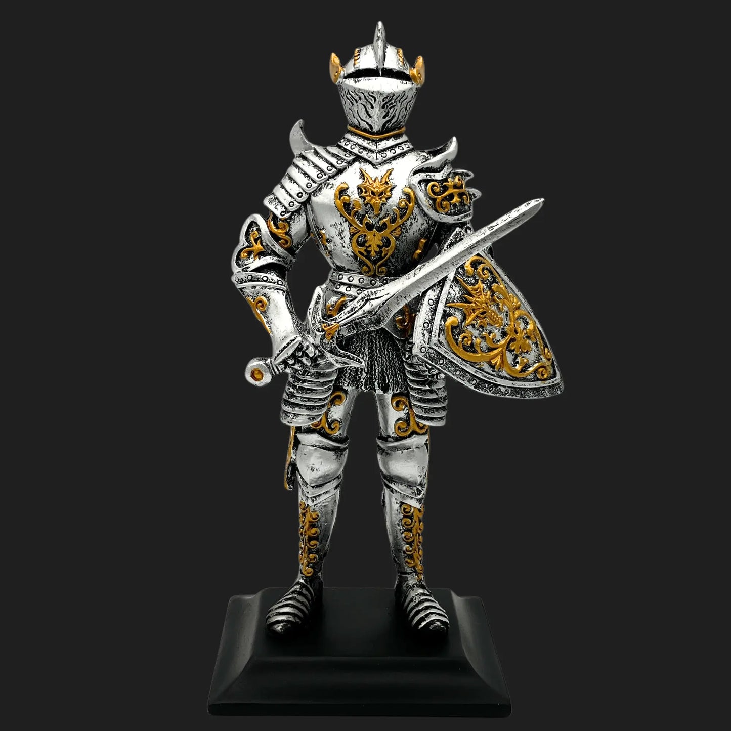Front view of Knight of the Dragon Order statue in full silver armor with golden dragon motifs and shield