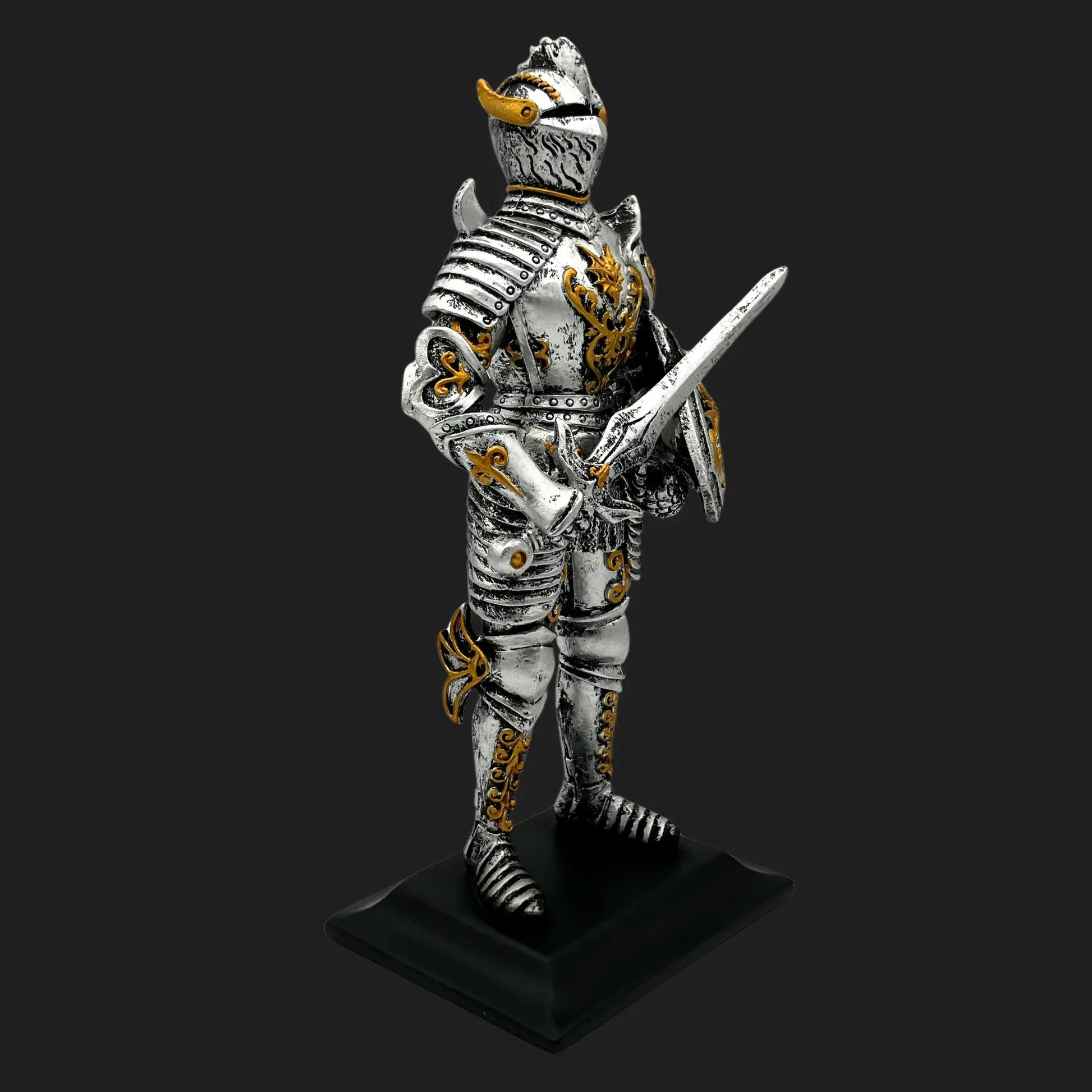Side angle of Knight of the Dragon Order statue with detailed armor, golden engravings, and raised sword