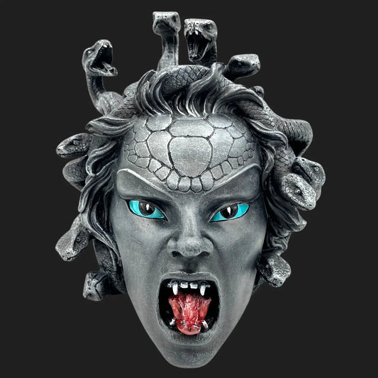 A detailed Gorgon Medusa face with open mouth, fangs, and serpent hair, crafted in stone-like resin.