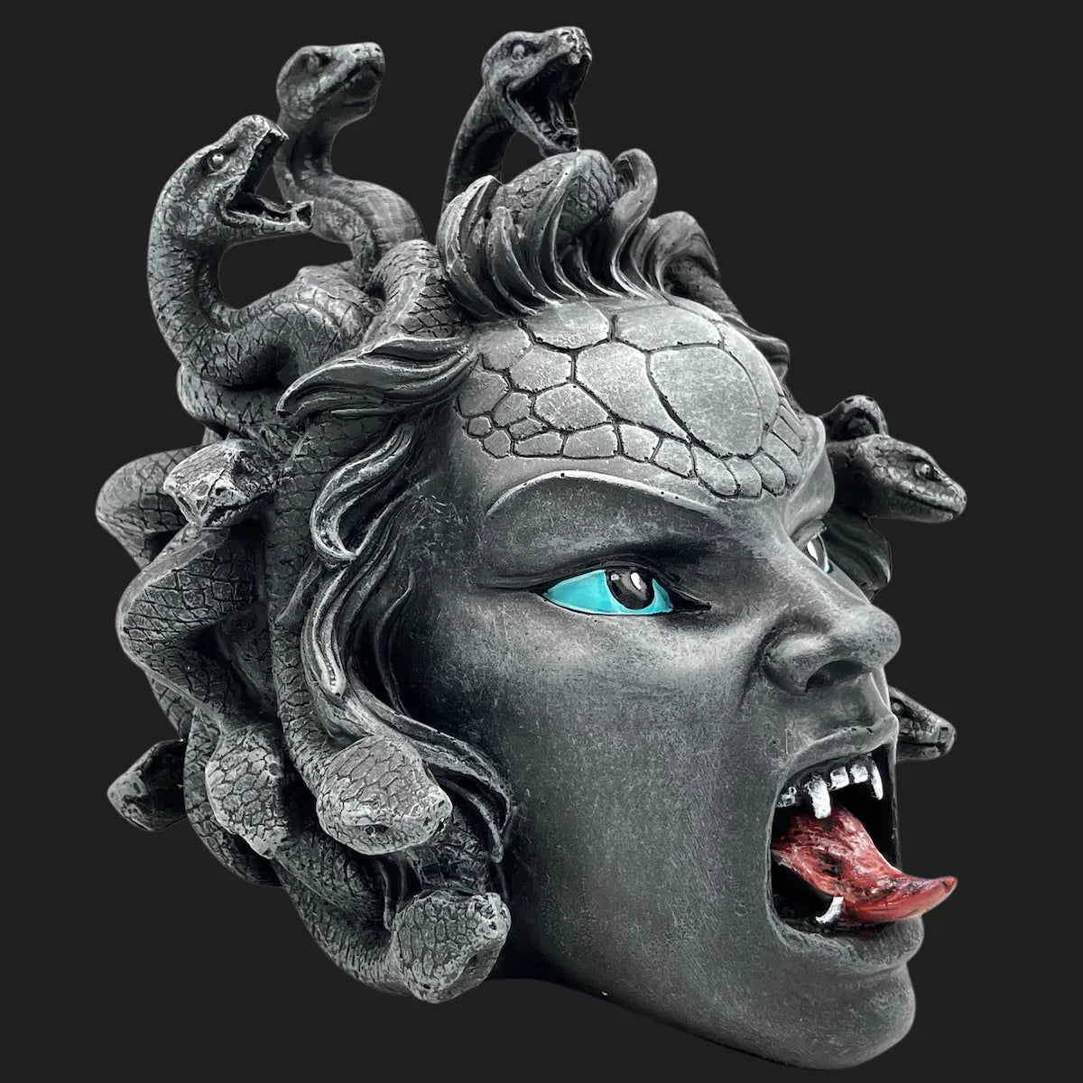 Mythical Medusa replica showing snakes coiled in her hair, fangs bared, and vivid eyes.