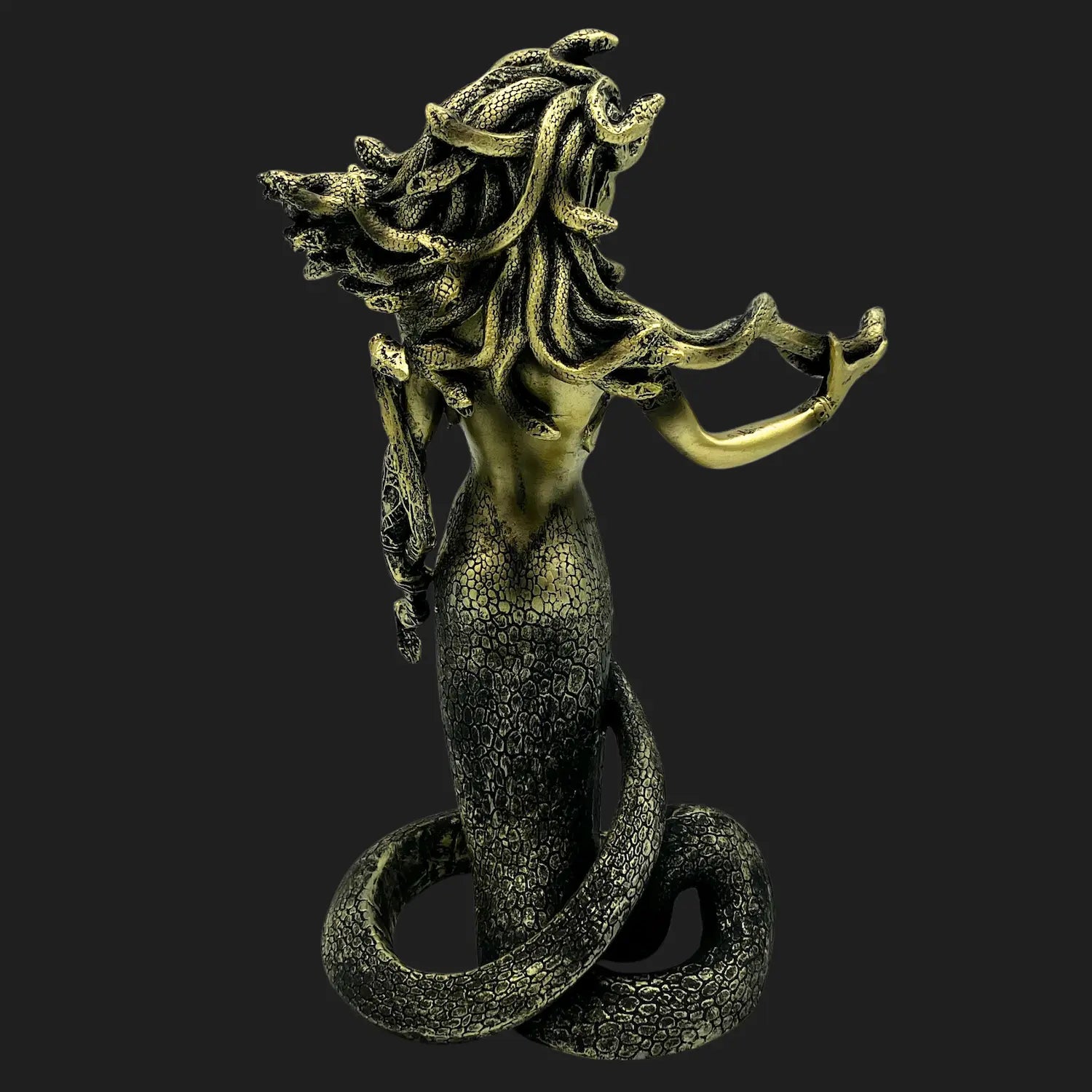 Back view of Medusa figurine showing coiled serpent tail and intricate scales