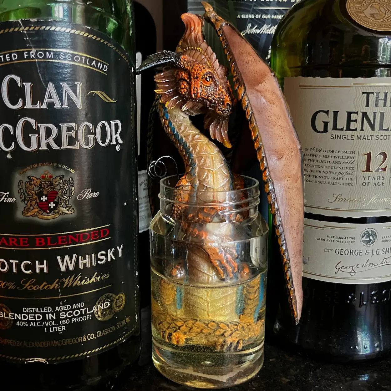 The Moonshine Dragon guarding bottles on a home bar