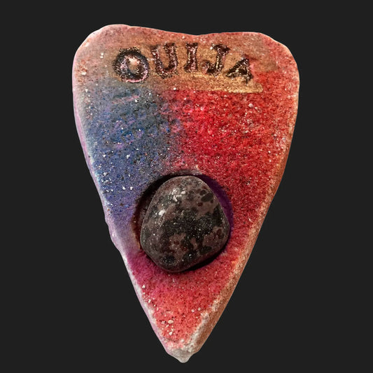 Ouija planchette bath bomb in red and purple with crystal stone embedded