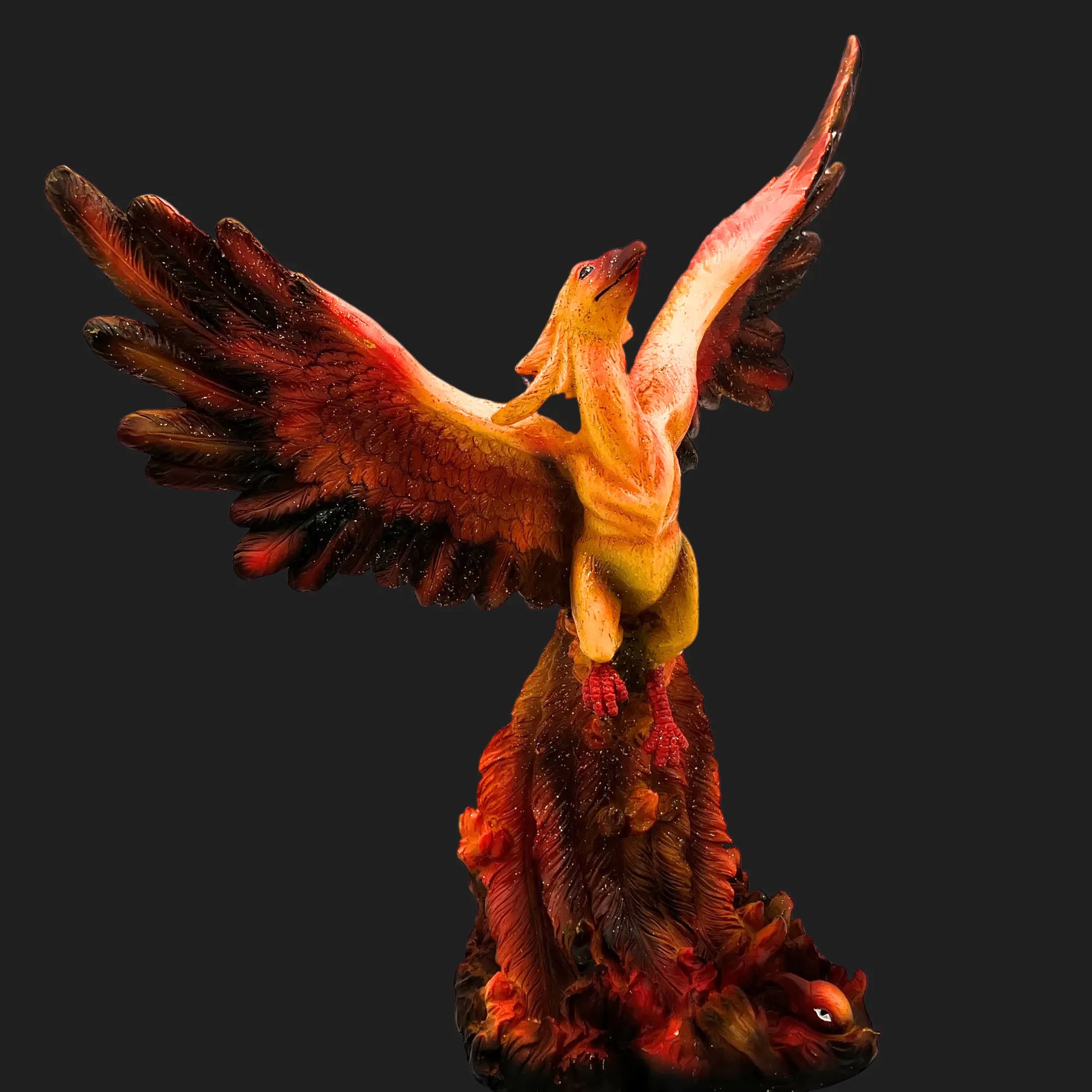 Side angle of Phoenix Rising collectible showing detailed flame base