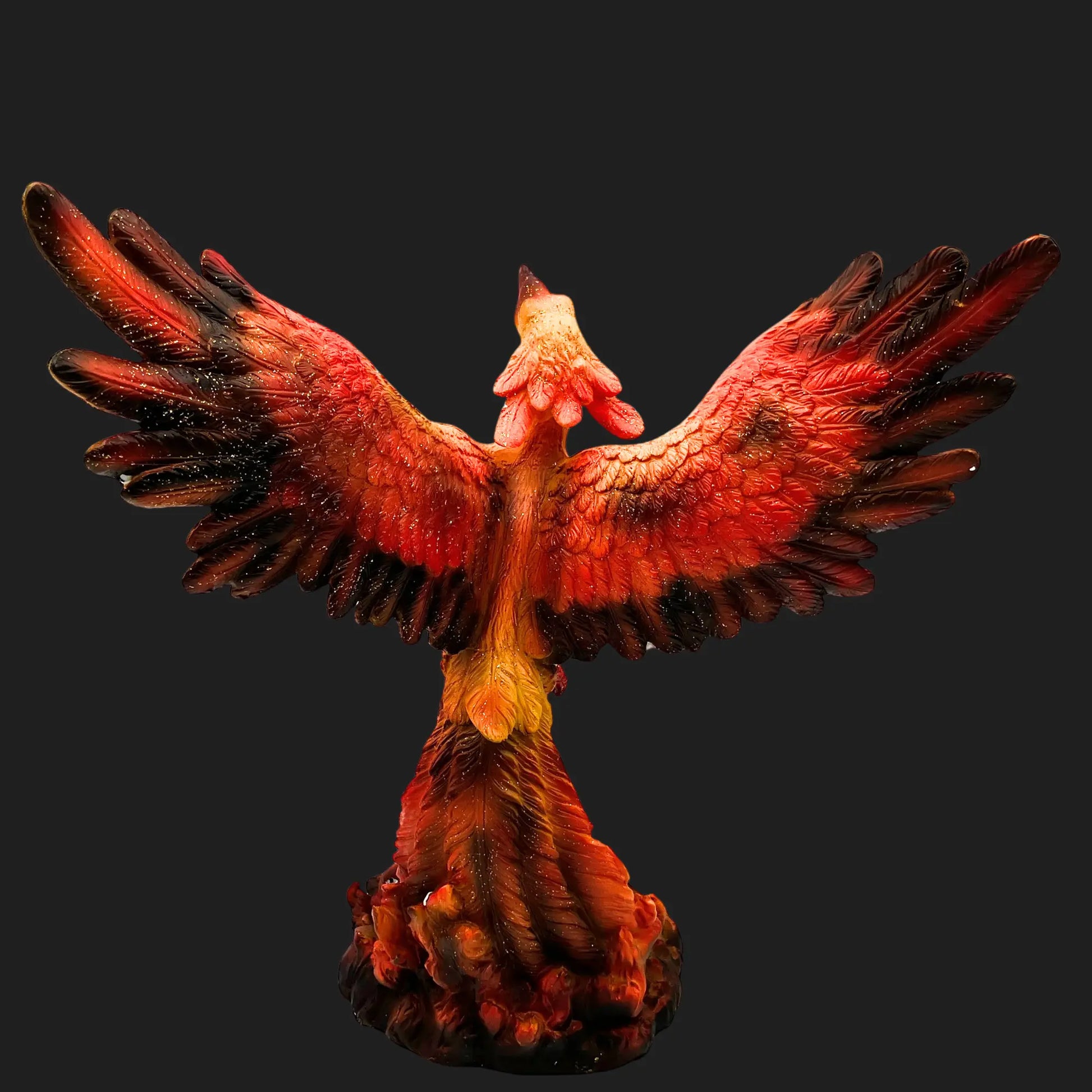 Back view of Phoenix Rising figurine highlighting flame-scorched wings