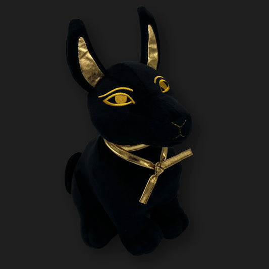 Front view of plush Anubis plushie sitting upright with golden embroidered details – Egyptian guardian stuffed toy