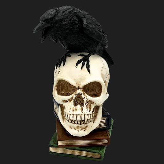 Poe’s Raven Skull Statue – black crow perched on cracked skull and books, gothic decor