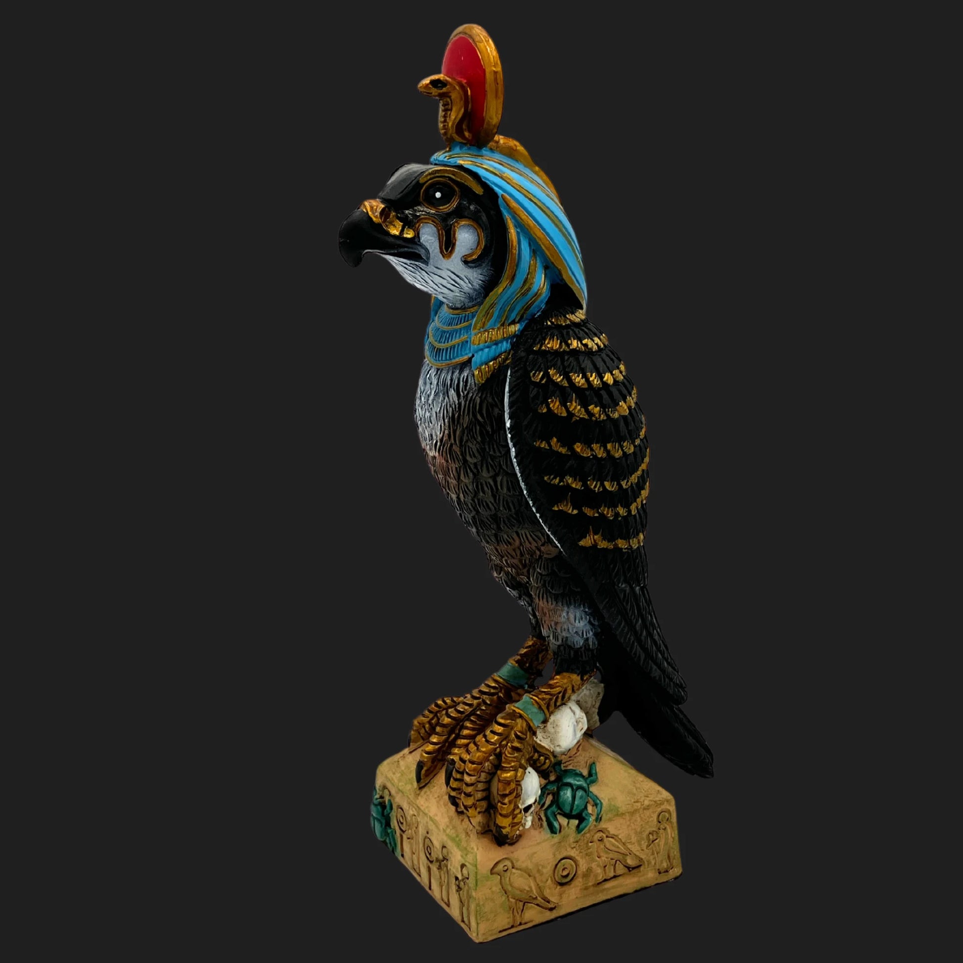 Egyptian god Ra statue with falcon head, sun disk crown, and cobra emblem — detailed mythic figurine on hieroglyphic base.