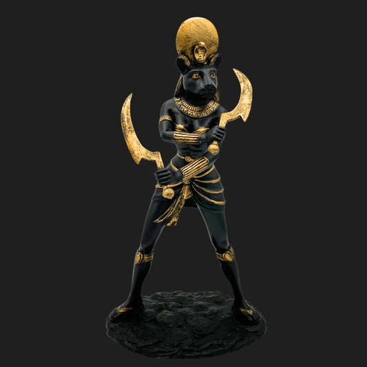 Front view of Sekhmet Egyptian goddess statue with lioness head, golden crown, and dual scythe weapons