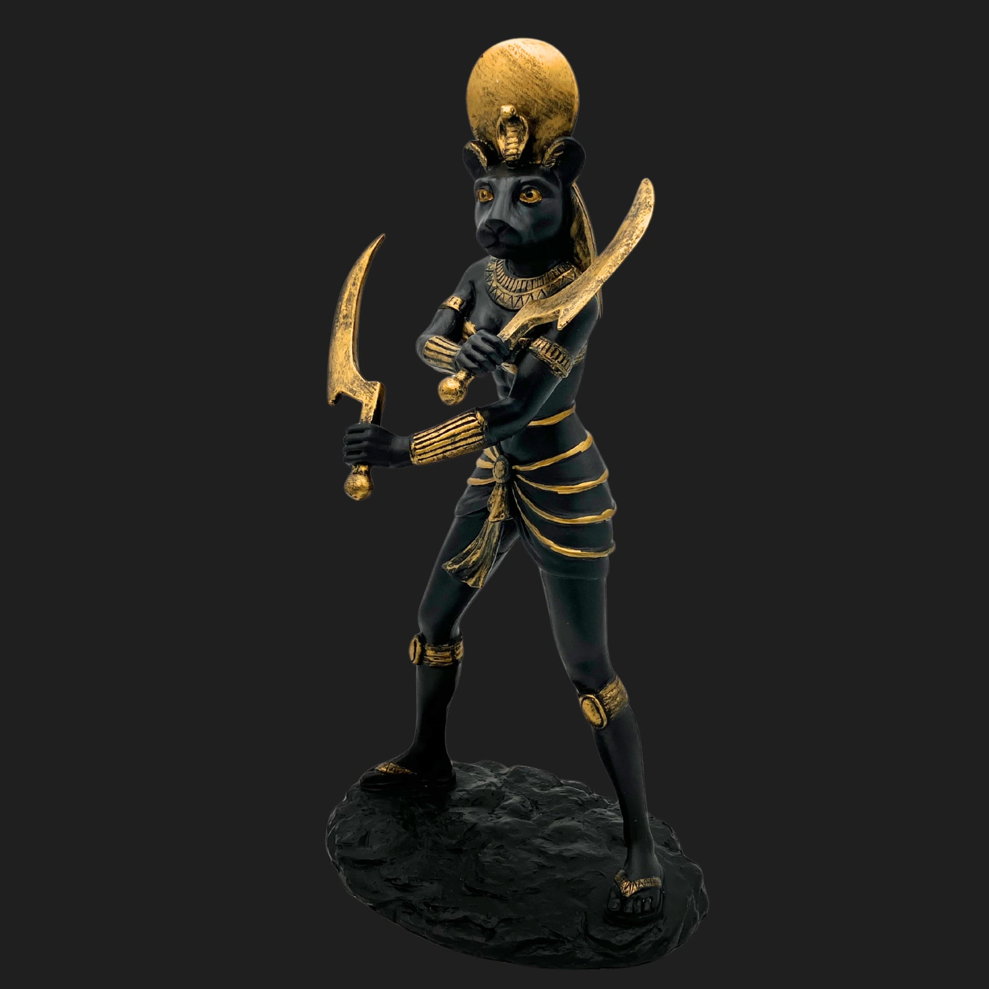 Side angle of Sekhmet statue, Egyptian lioness goddess of war and protection, holding golden scythes