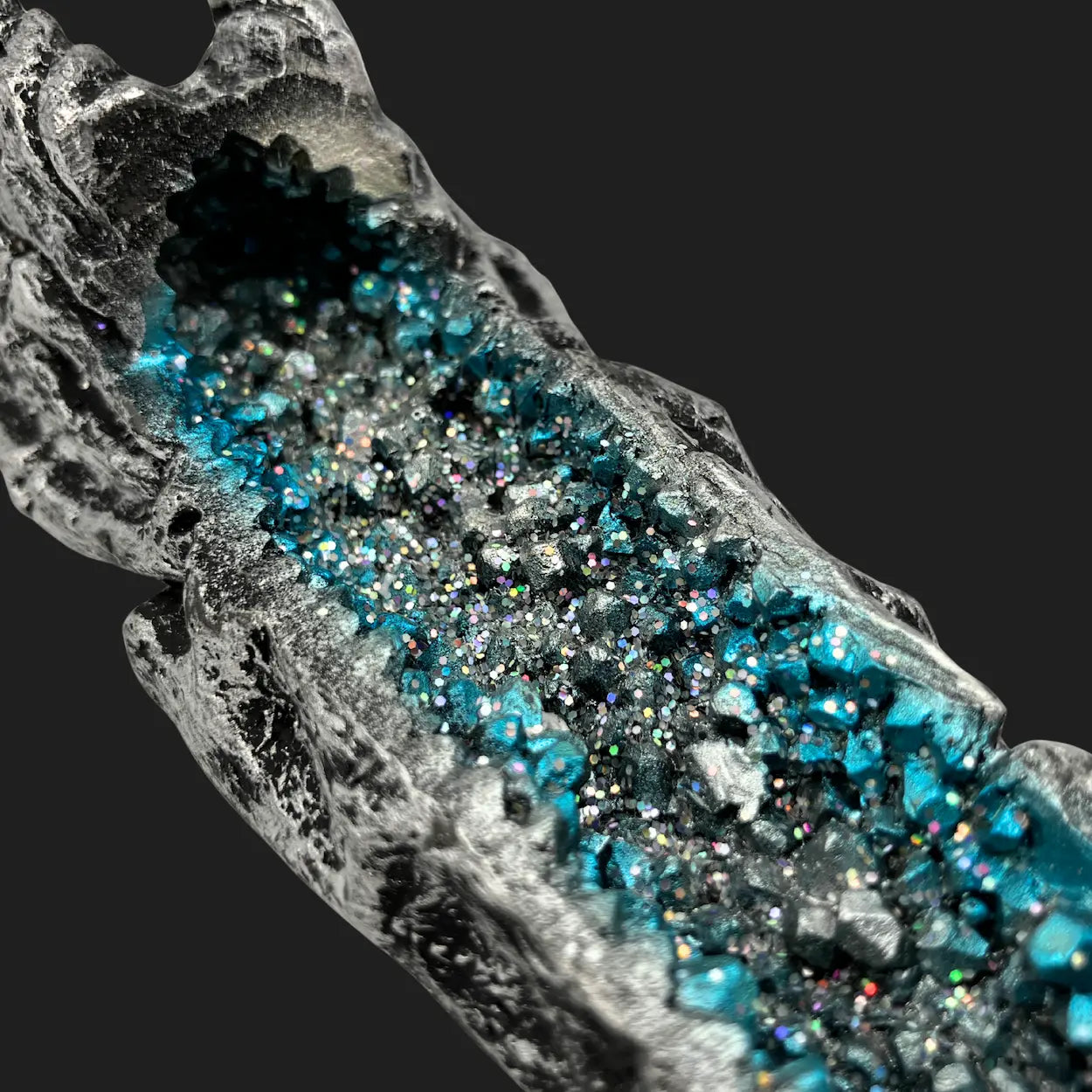 Close-up of blue crystal-lined ash chamber inside silver dragon skull incense burner