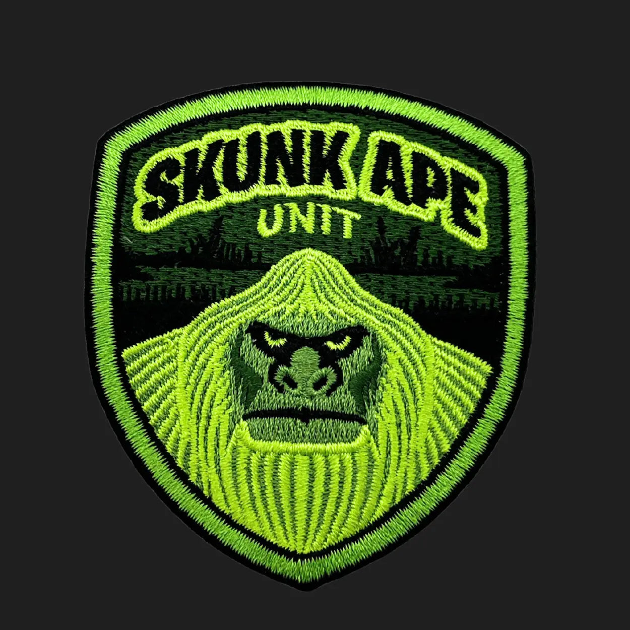 Embroidered Skunk Ape Unit iron-on patch, 3x3 inches, featuring Florida swamp ape cryptid face in neon green badge design.