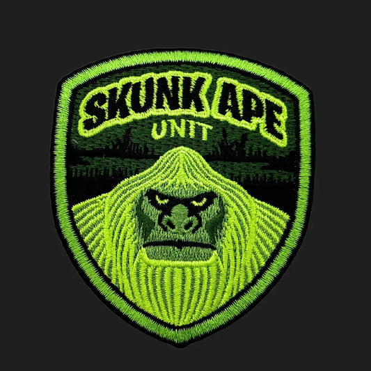 Embroidered Skunk Ape Unit iron-on patch, 3x3 inches, featuring Florida swamp ape cryptid face in neon green badge design.