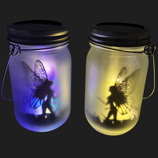 Solar powered fairy jars glowing in yellow and blue light with fairy inside