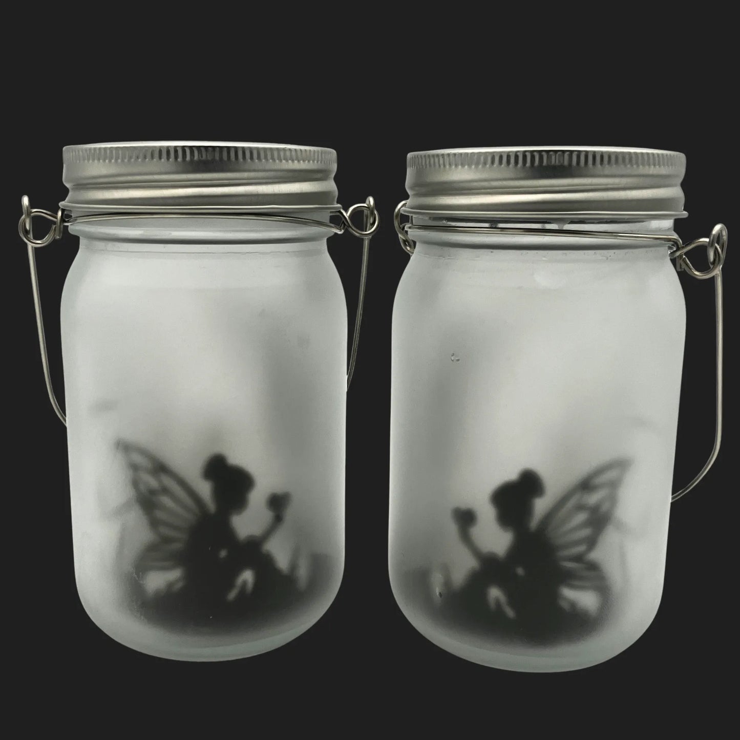 Solar powered fairy jar with sitting fairy silhouette holding a flower