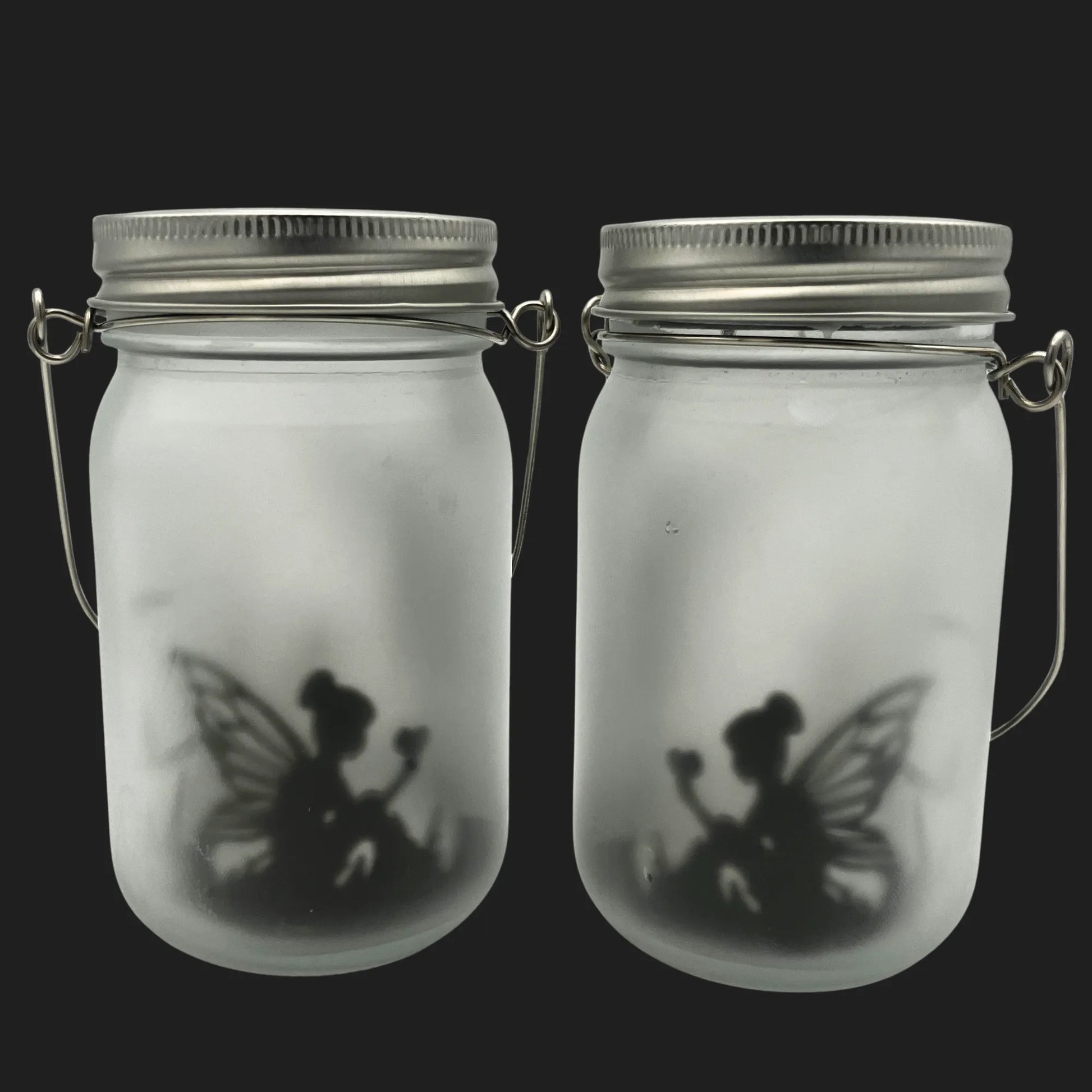 Solar powered fairy jar with sitting fairy silhouette holding a flower