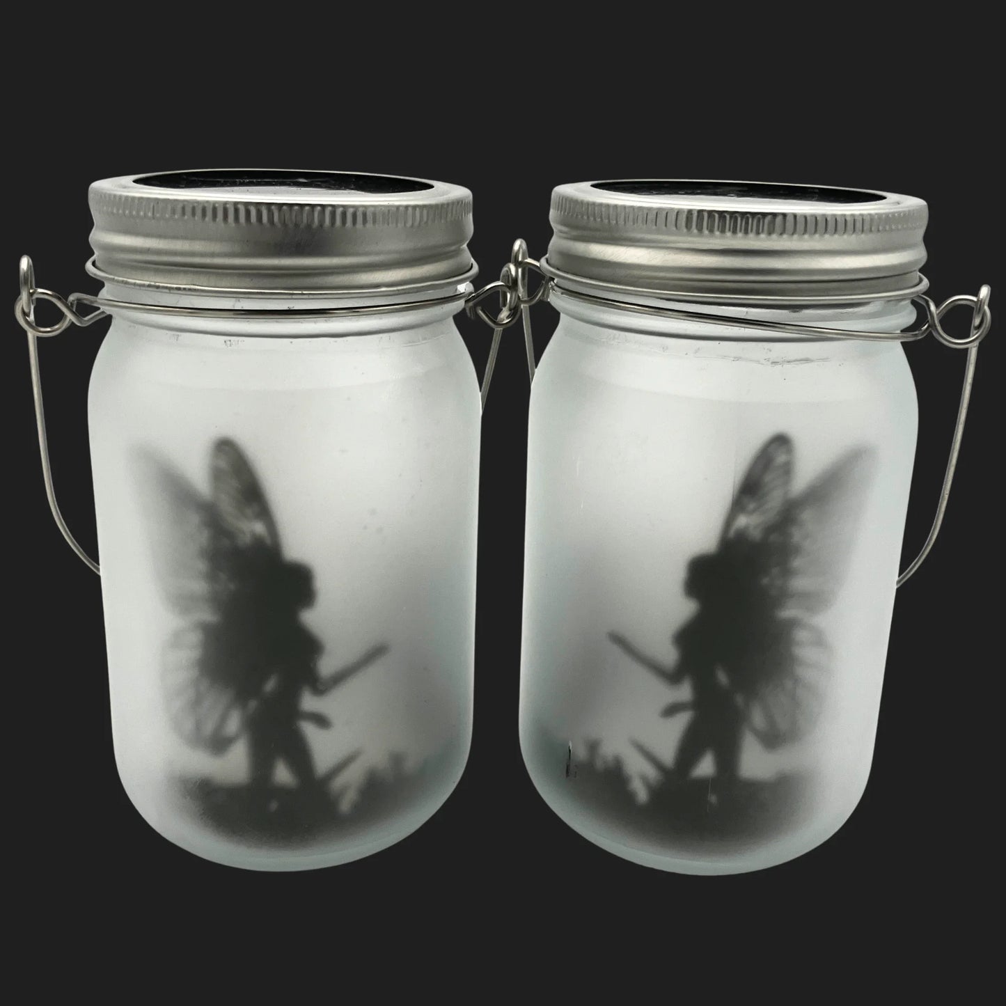 Solar powered fairy jar with glowing warrior fairy silhouette in frosted glass lantern