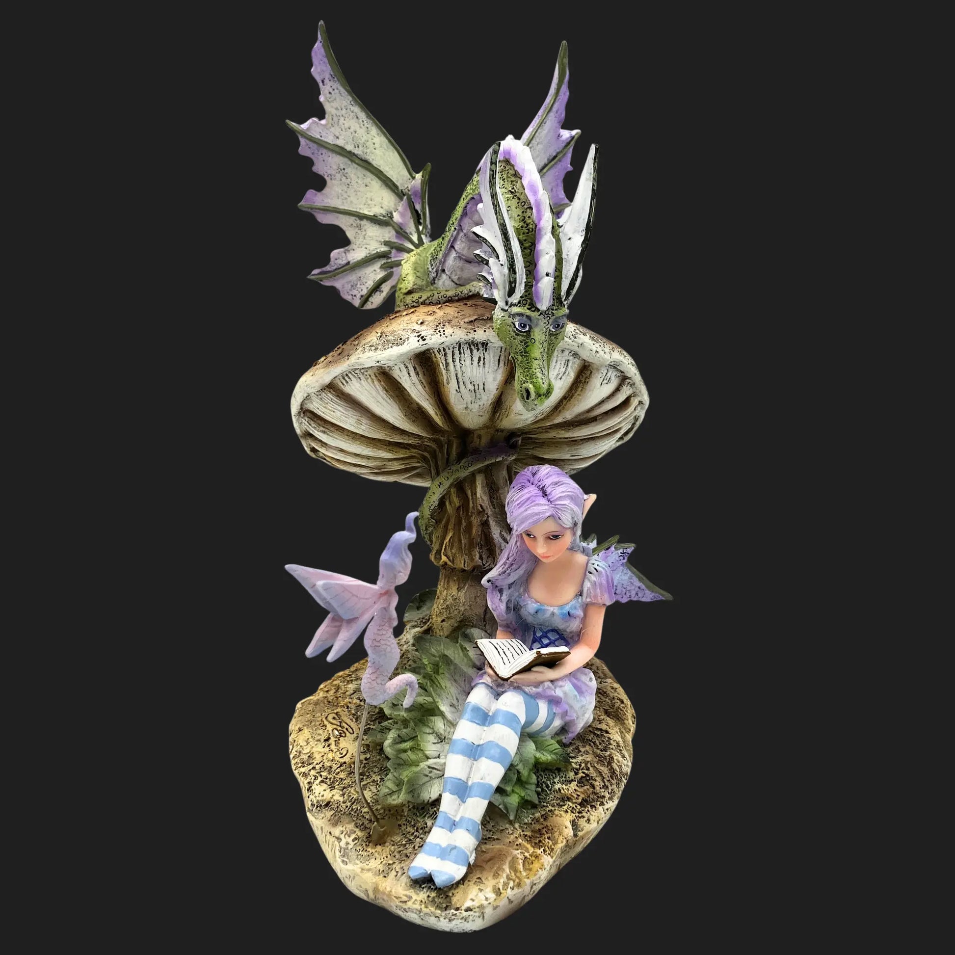Side view of the Storykeeper fairy statue, showing her purple wings, striped stockings, and dragon companion.