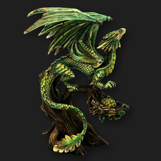 Side view of Tree Dragon Figurine with green scales and extended wings perched on tree