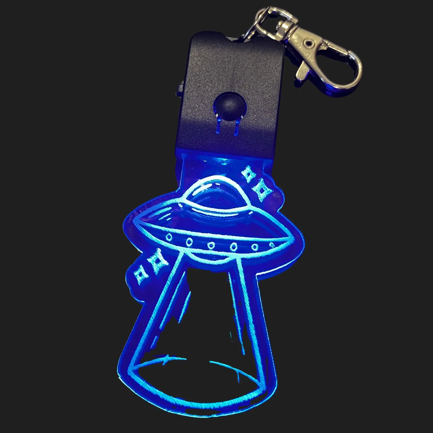 UFO LED keychain glowing blue with etched spaceship and beam