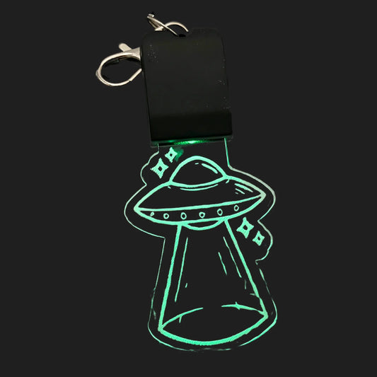 UFO LED charm glowing green with abduction beam design
