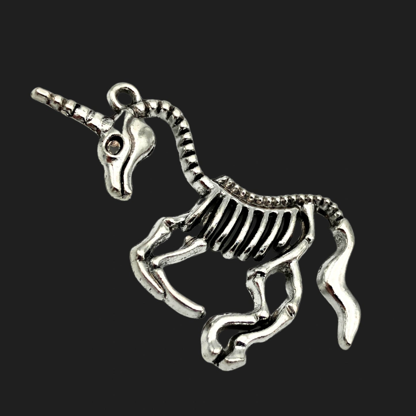 Unicorn skeleton pendant with ribcage body and horn – gothic fantasy charm